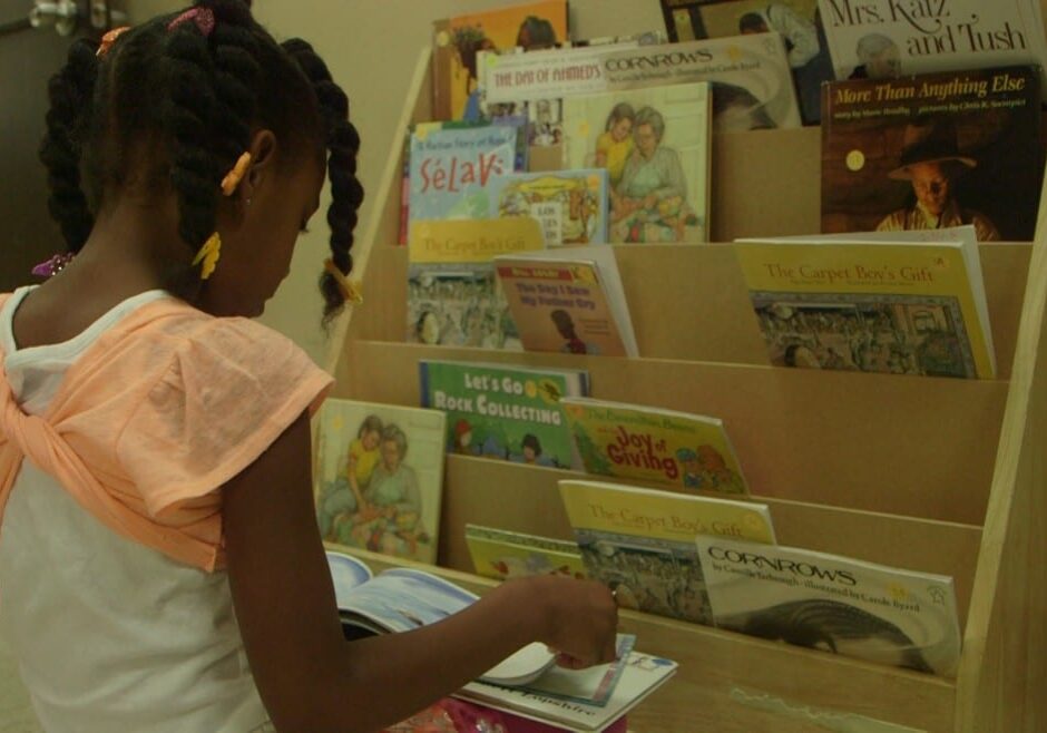 Girl choosing books from shelf
