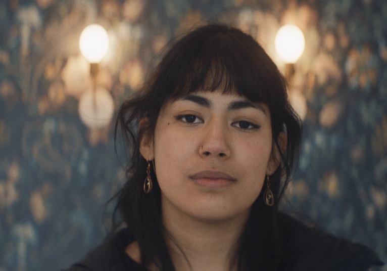 A barista at the Monarch cafe in Kansas City looks into the camera