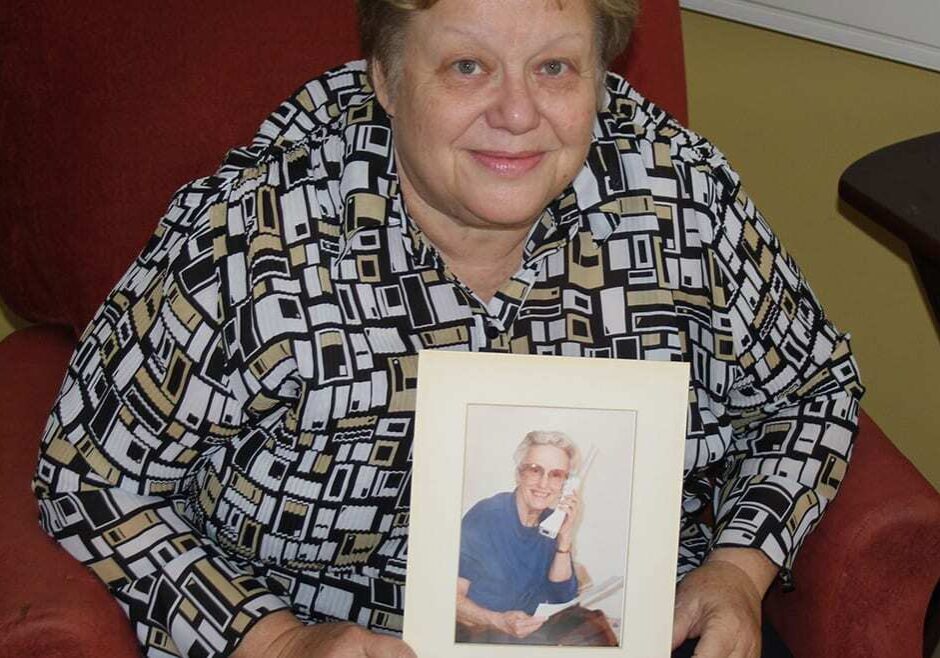 Judy Bellome, of Lawrence, helped cared for her diabetic mother until her death. Bellome is now among those supporting a bill to require more instruction for caregivers before patients are discharged from the hospital. She's holding a picture of her mother, Eleanor Francis. (Photo by Andy Marso/KHI News Service)