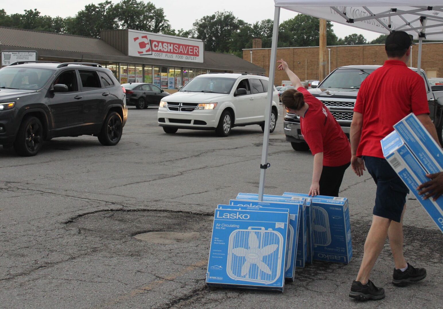 Volunteers prepare to hand out fans during a distribution event hosted by the Salvation Army and Westlake ACE Hardware.