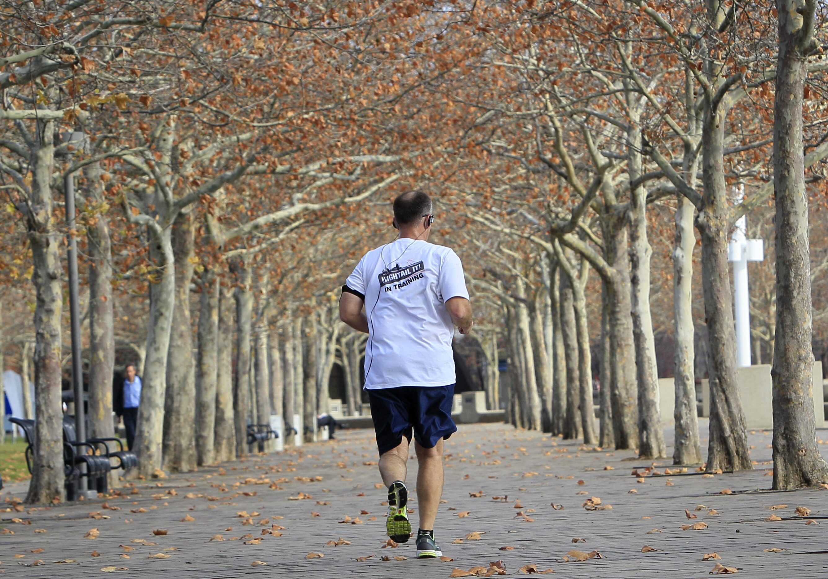 A man jogs through a park along the Ohio River, Monday, Dec. 3, 2012, in Cincinnati, where temperatures were expected to approach 70 degrees. (AP Photo/Al Behrman)