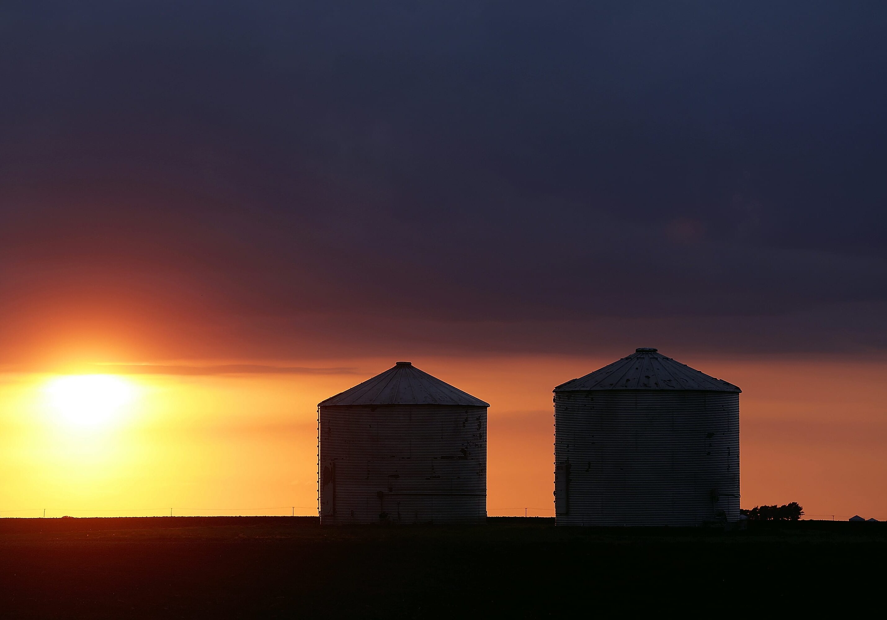 Storm clouds form over central Illinois corn and soybean grain bins Tuesday, May 21, 2013, in Pleasant Plains, Ill. Farmers and rural residents are paying close attention to weather forecast predicting destructive weather and tornados in the Midwest. A huge tornado roared through the Oklahoma City suburb Monday, flattening an entire neighborhoods and destroying an elementary school with a direct blow as children and teachers huddled against winds. (AP Photo/Seth Perlman)