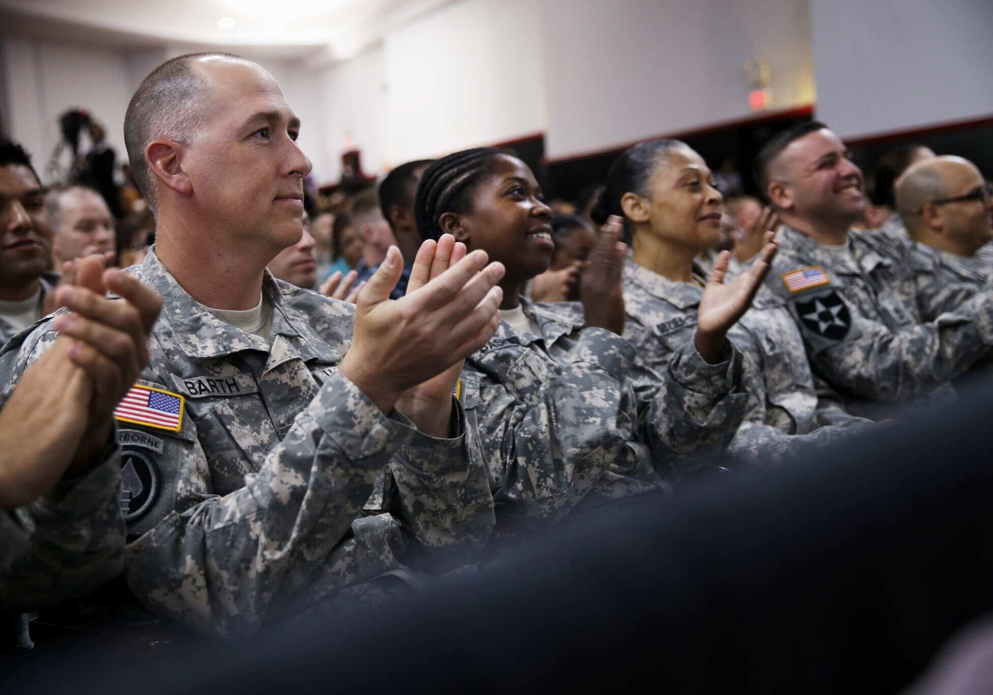 Members of the military applaud as President Barack Obama speaks about H.R. 3230, the Veterans Access to Care through Choice, Accountability, and Transparency Act of 2014, Thursday, Aug. 7, 2014, at the Wallace Theater in Fort Belvoir, Va. The bill gives resources to the Department of Veterans Affairs to improve access and quality of care for veterans. (AP Photo/Jacquelyn Martin)