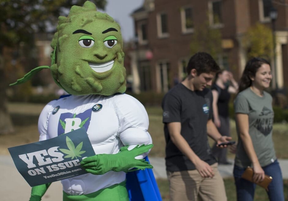 Buddie, the mascot for the pro-marijuana legalization group ResponsibleOhio, greets college students. The smiling green bud's superhero looks drew criticism and some blame for the the failure of a ballot proposal that would have been the first in the Midwest to take marijuana use and sales from illegal to legal for both personal and medical use in a single vote. (Photo: John Minchillo | AP)