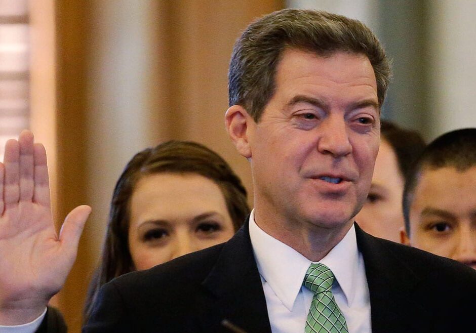 Kansas Gov. Sam Brownback is sworn in by Chief Justice Lawton Nuss during his Inaugural Ceremony Monday, Jan. 12, 2015, in Topeka, Kan. (AP Photo/Charlie Riedel)