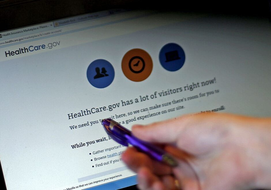 Elizabeth Rich points to a web page for the Affordable Care Act as she helps people sign up for health insurance at Swope Health Services Monday, March 31, 2014, in Kansas City, Mo. Today is the deadline to sign up for an Affordable Health Care insurance plan however, people who begin the enrollment process but aren't able to complete it by 11:59 p.m. because of a system issue may qualify for a special provision that will allow them to enroll after Monday night. (AP Photo/Charlie Riedel)