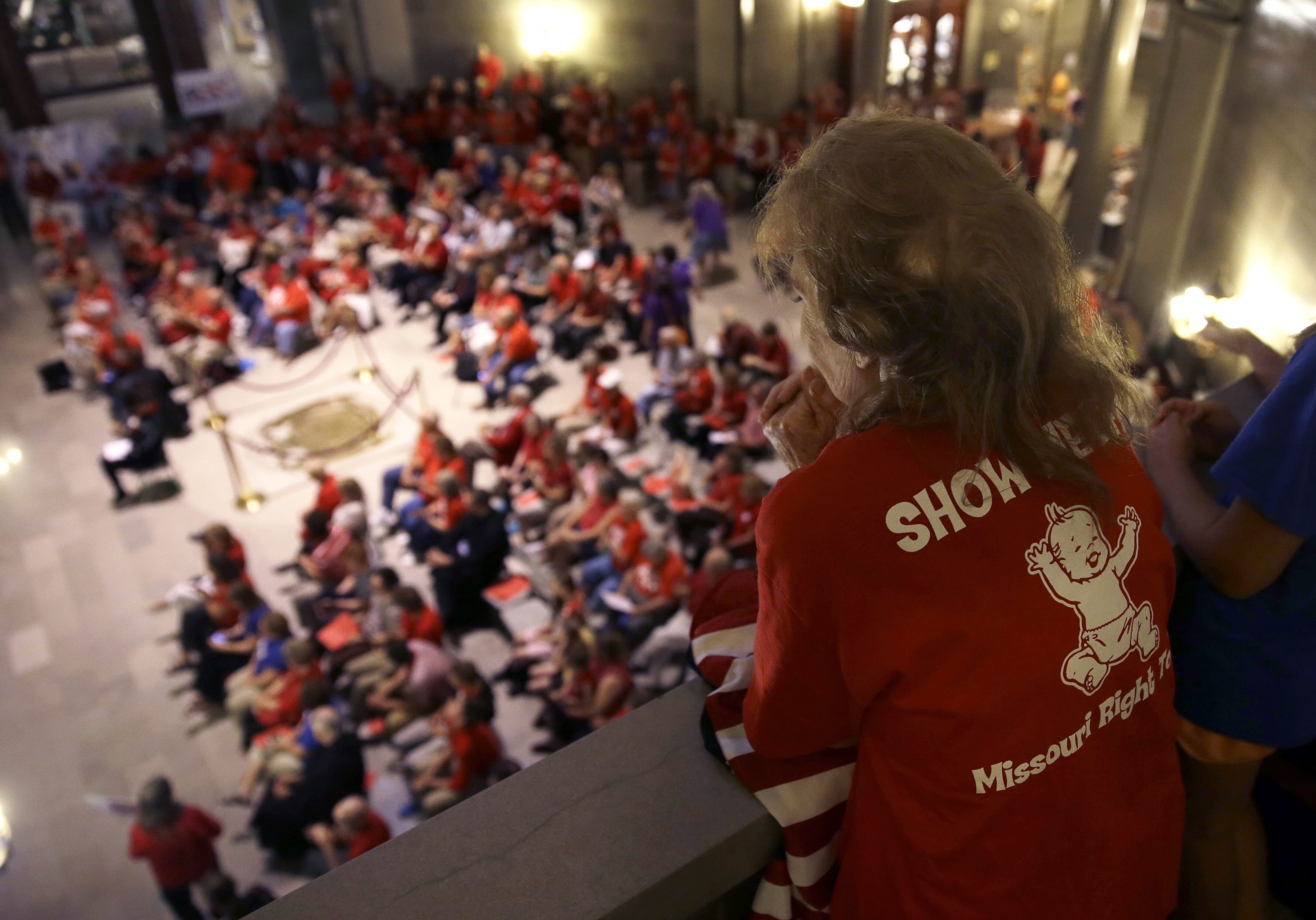 Elizabeth War looks over a gathering of her fellow abortion opponents in the Missouri Capitol rotunda Wednesday, Sept. 10, 2014, in Jefferson City, Mo. Missouri lawmakers will consider whether to override a veto by Gov. Jay Nixon of legislation requiring a 72-hour waiting period for abortions, one of the longest mandatory delays in the nation, during a special legislative session that begins Wednesday. (AP Photo/Jeff Roberson)