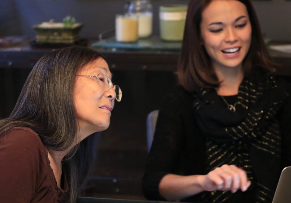 Laupie Yasui, left, looks at photos of her father, Minoru Yasui, with her daughter Chani Hawkins in Kansas City. Laupie Yasui and Hawkins traveled to Washington D.C. to receive today the Presidential Medal of Freedom on his behalf. (Photo: Orlin Wagner | AP)