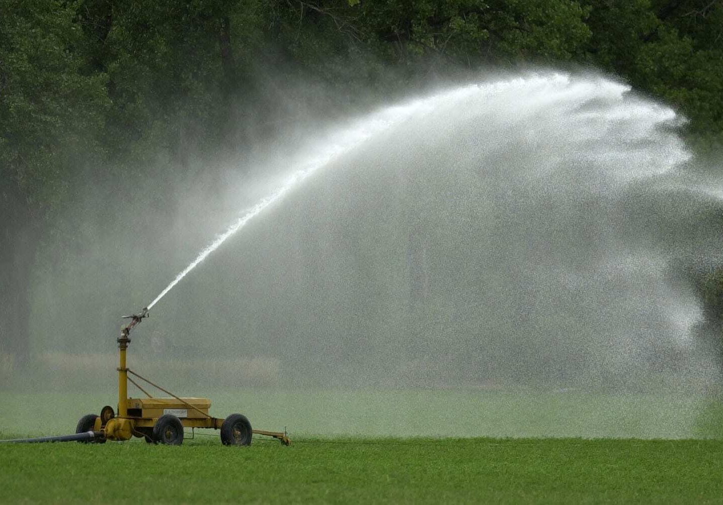 FILE - In this Aug. 28, 2003 file photograph, a sprinkler sprays water onto a hay field near Hoxie, Kan. The administration of Gov. Sam Brownback is moving forward on a plan for the states long-term water supply. The plans more ambitious parts include dredging state lakes and possibly building an aqueduct from the Missouri River to western Kansas, the Lawrence Journal-World reported. In western Kansas, farm irrigation is depleting the underground Ogallala Aquifer, while in some counties, irrigation has been forced to halt entirely. (AP Photo/Charlie Riedel, File)