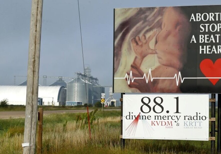 An anti-abortion sign next to a highway.