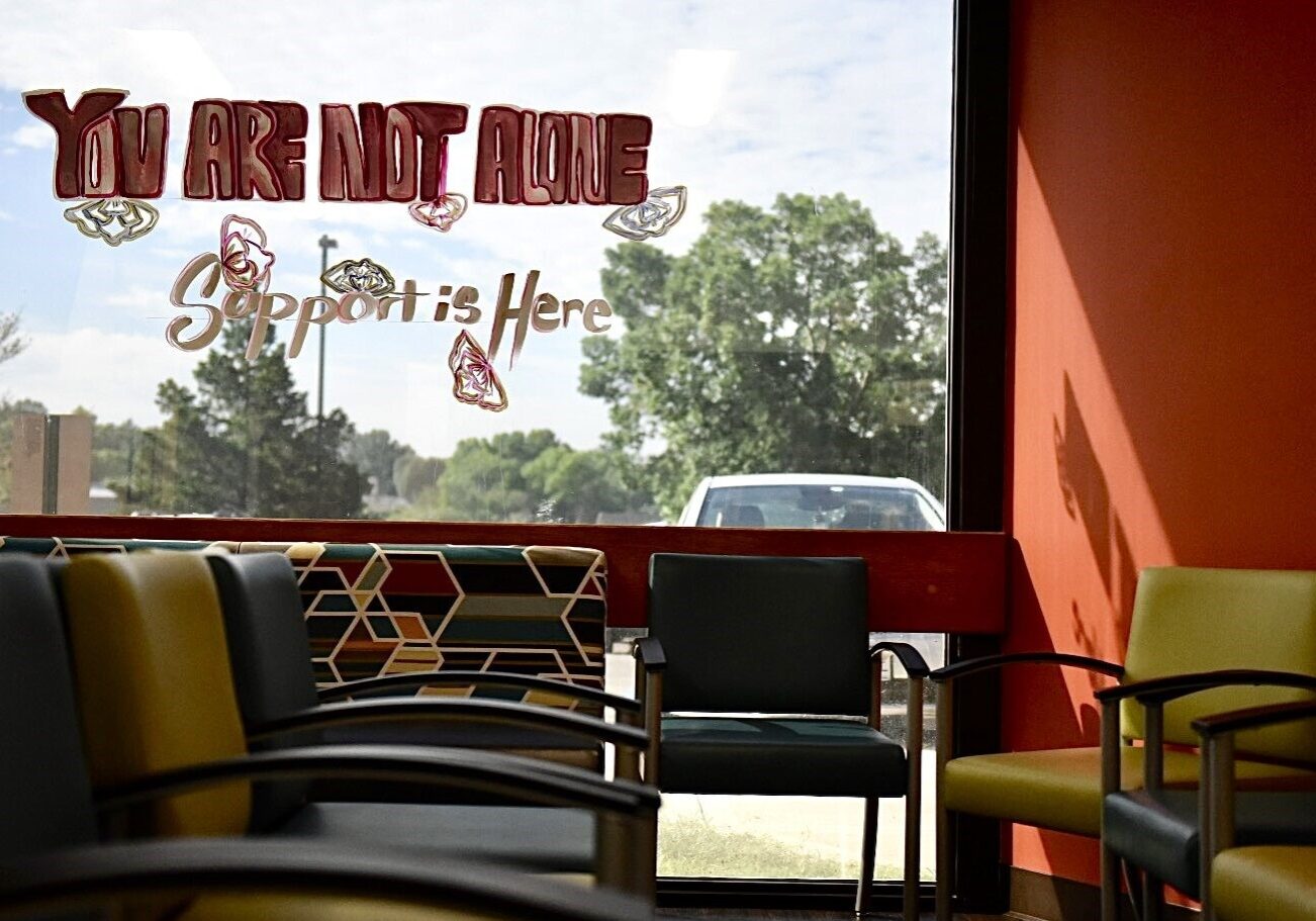 The message “You are not alone, support is here” is painted on the window of the Planned Parenthood Great Plains on Friday in Overland Park, Kansas.