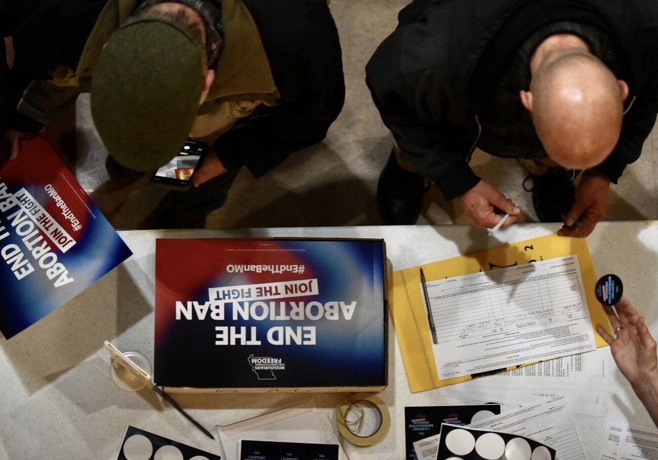 Supporters sign an initiative petition in support of a ballot measure that would legalize abortion up to the point of fetal viability in Missouri. during an event on Feb. 6, 2024, in Kansas City hosted by Missourians for Constitutional Freedom.