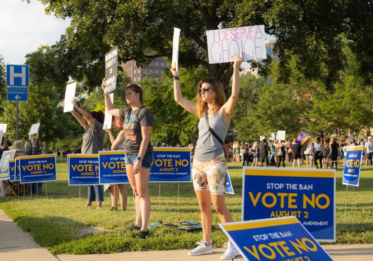 People at a rally for abortion access at Mill Creek Park near the Country Club Plaza.