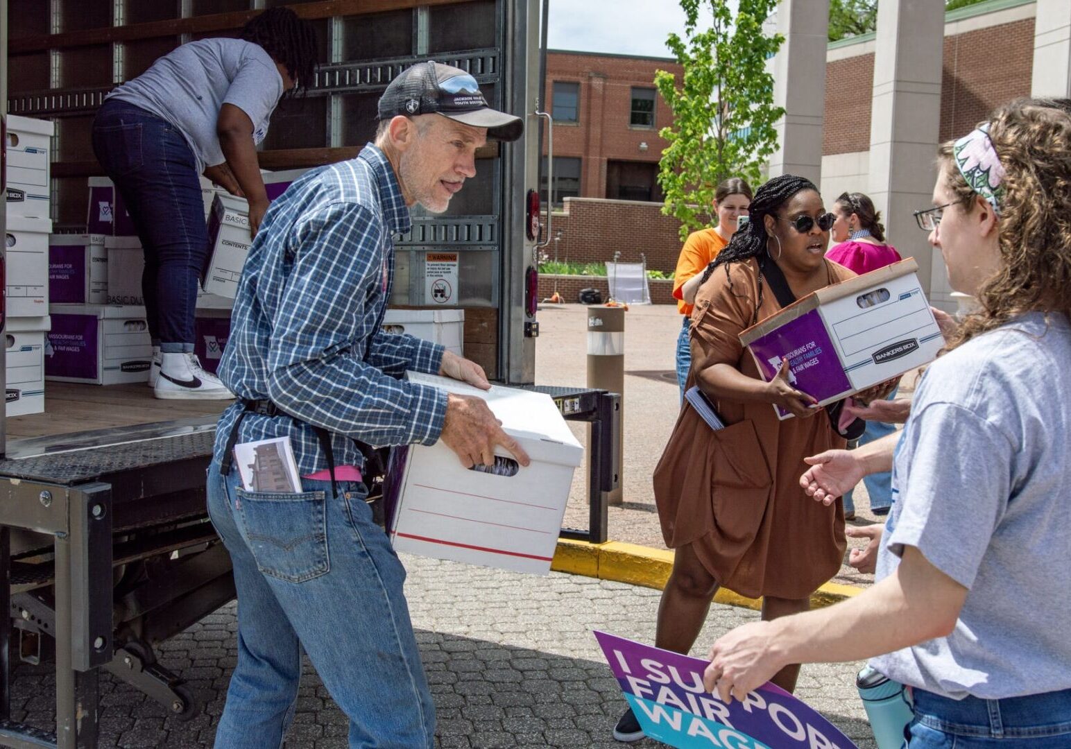 Petitioners with Missourians for Healthy Families and Fair Wages unload dozens of boxes of signatures to deliver to the Secretary of State.