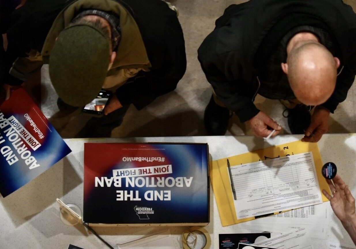 Supporters sign an initiative petition in support of a ballot measure that would legalize abortion up to the point of fetal viability in Missouri. during an event on Feb. 6, 2024, in Kansas City hosted by Missourians for Constitutional Freedom.