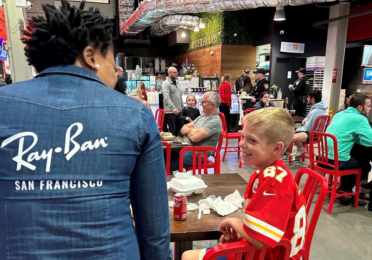Odin Smith of Lenexa shares a smile with Stella Musongong, who owns African Dream Cuisine with her husband Neba Ngwa. It was Odin’s first time dining at the food stall in Lenexa Public Market.