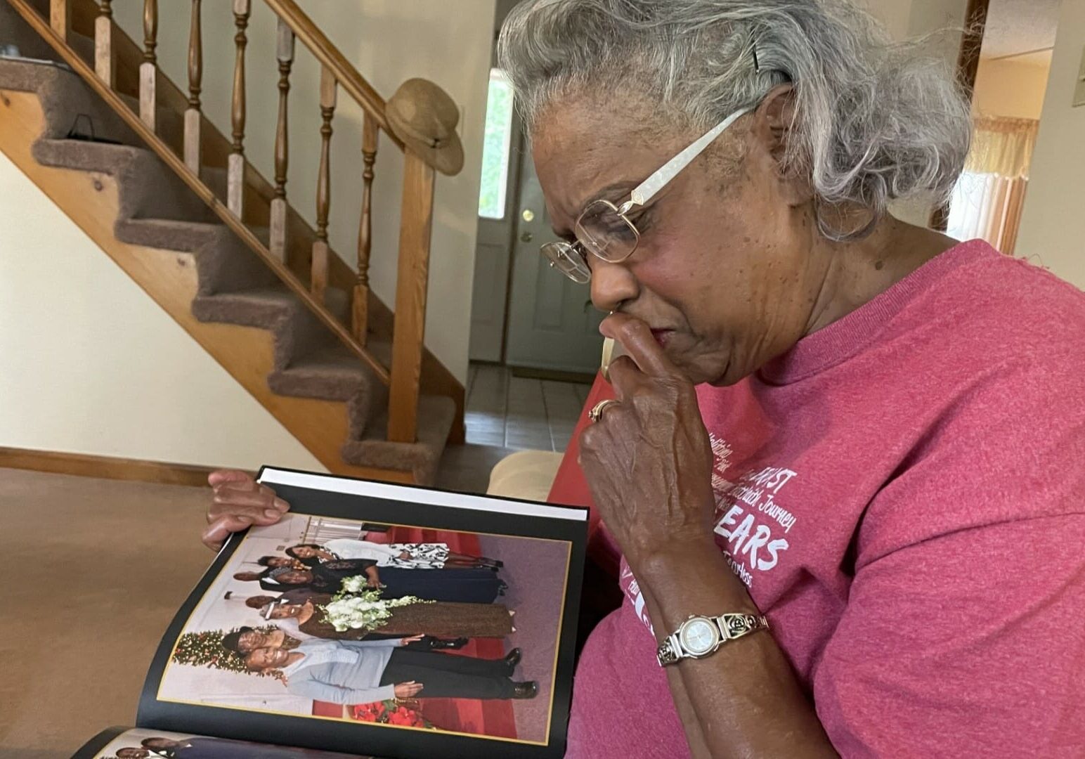 Iola Riley reminisces while looking at the photo album commemorating her and her husband Ernest's 50-year wedding anniversary.