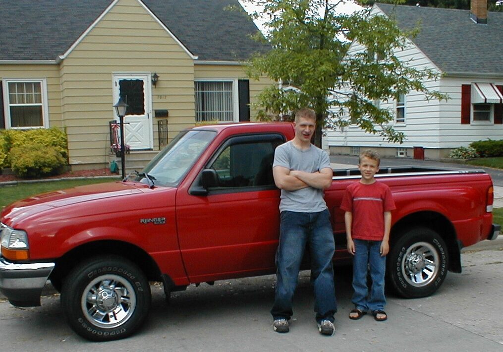 Michael Bell Jr. stands in front of his pickup truck with his younger brother, Taylor.