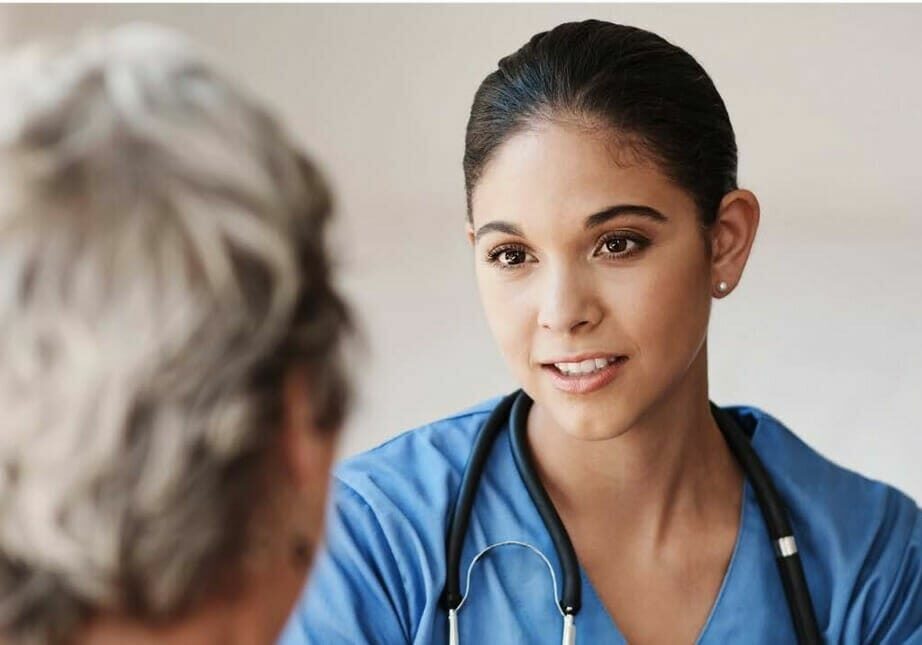 A caregiver meets with a patient.