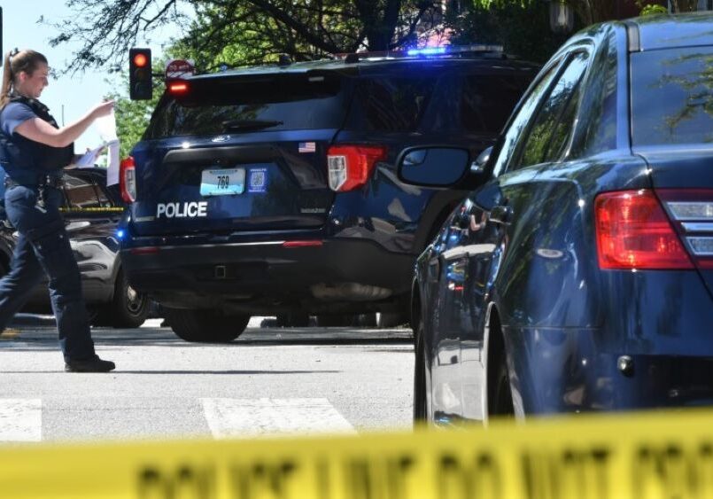 A police woman approaching a vehicle.