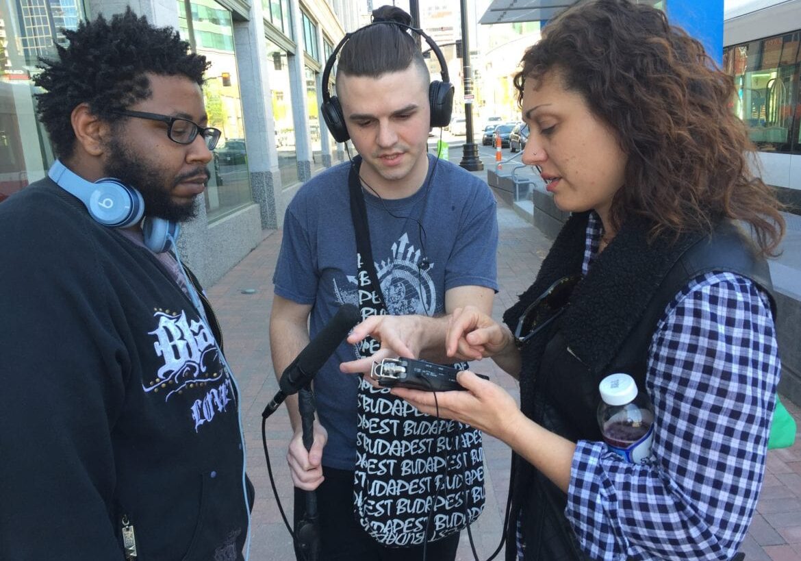 Three filmmakers talking on the street