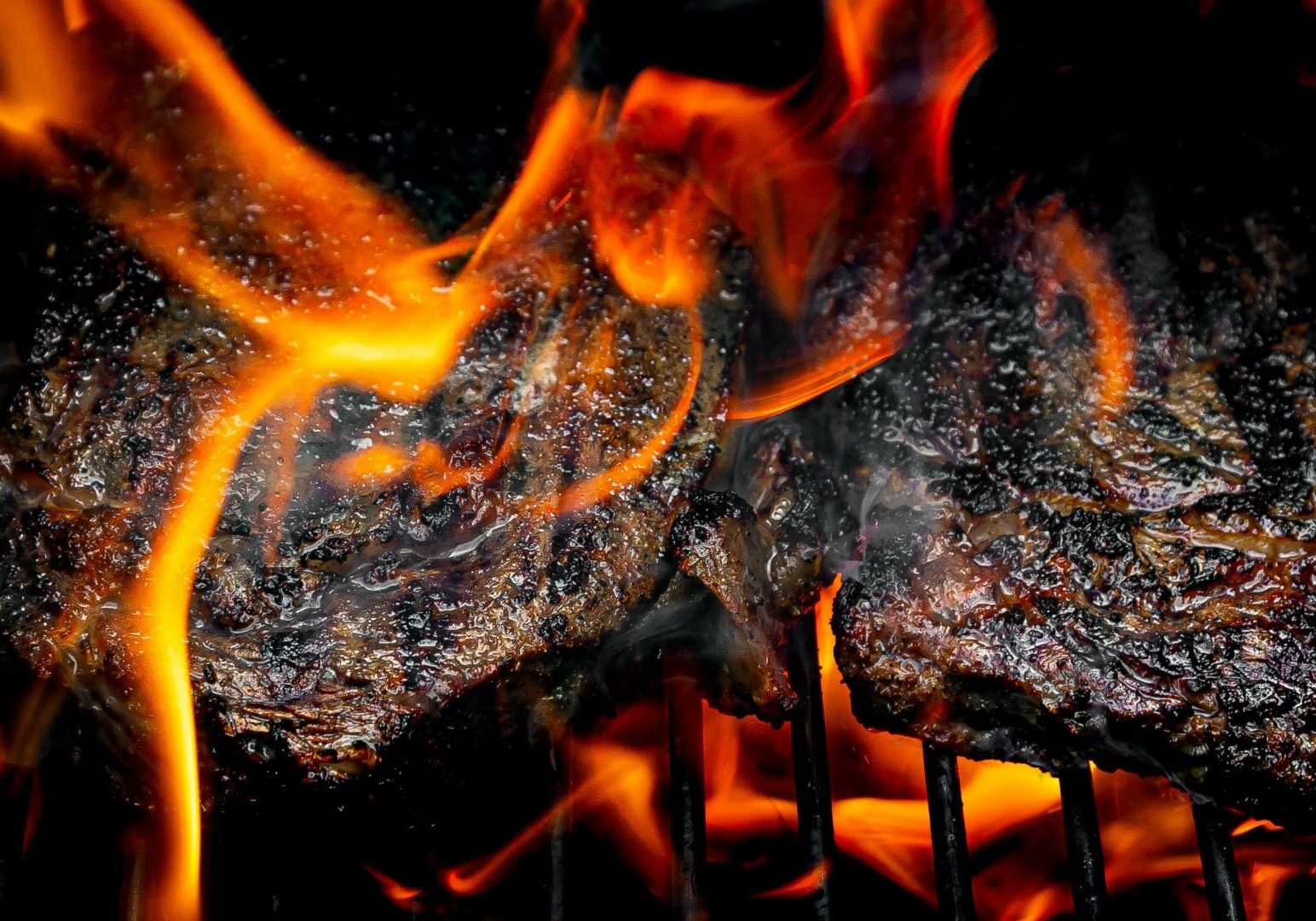 Barbecue engulfed in flames.