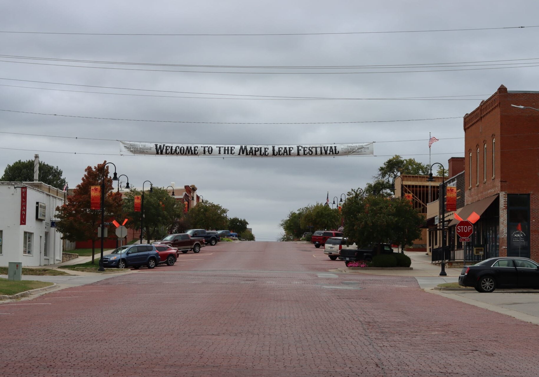 a banner hangs over the entrance to downtown Baldwin City. It reads "Welcome to the Maple Leaf Festival"