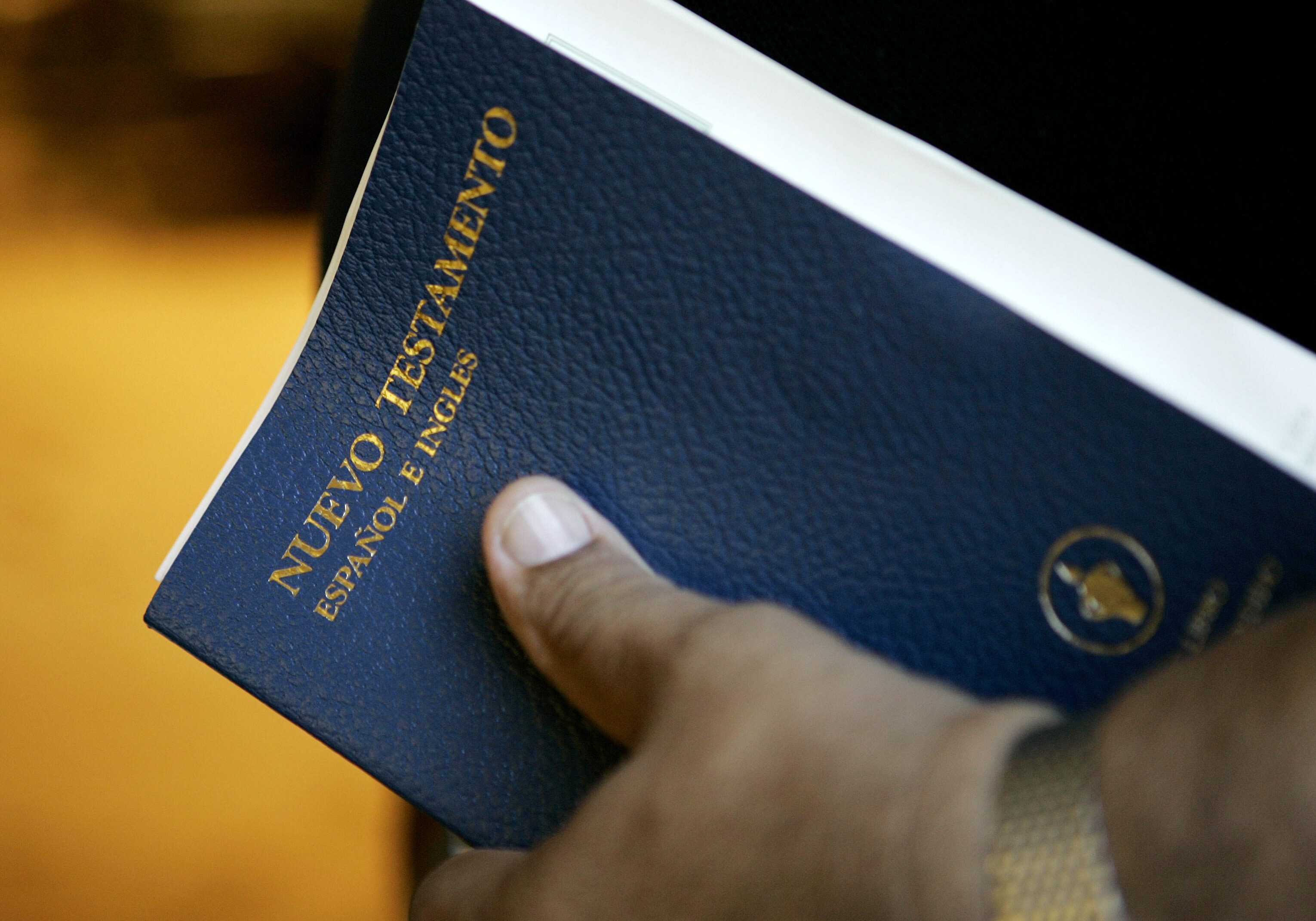 George Diaz holds a bilingual Bible as he attends services in Louisville, Ky. Services at the chapel are delivered in both English and Spanish. (Photo: Ed Reinke |AP)