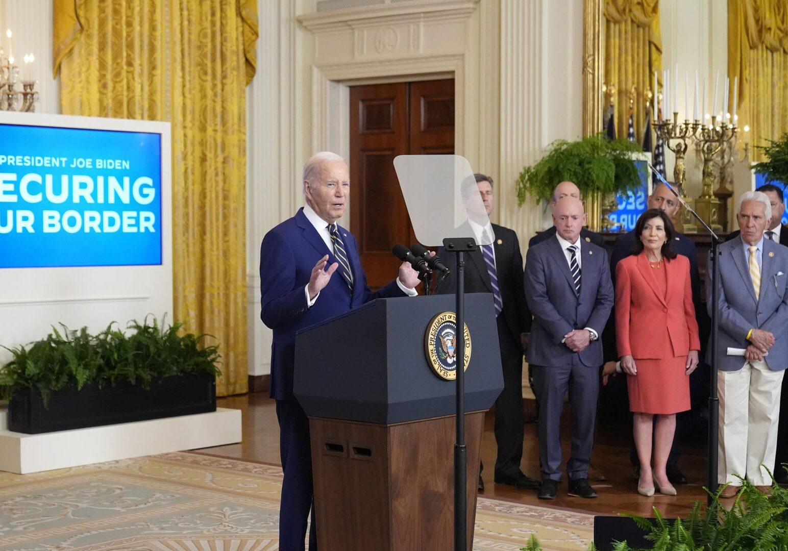 President Joe Biden, left, speaks about an executive order in the East Room at the White House.