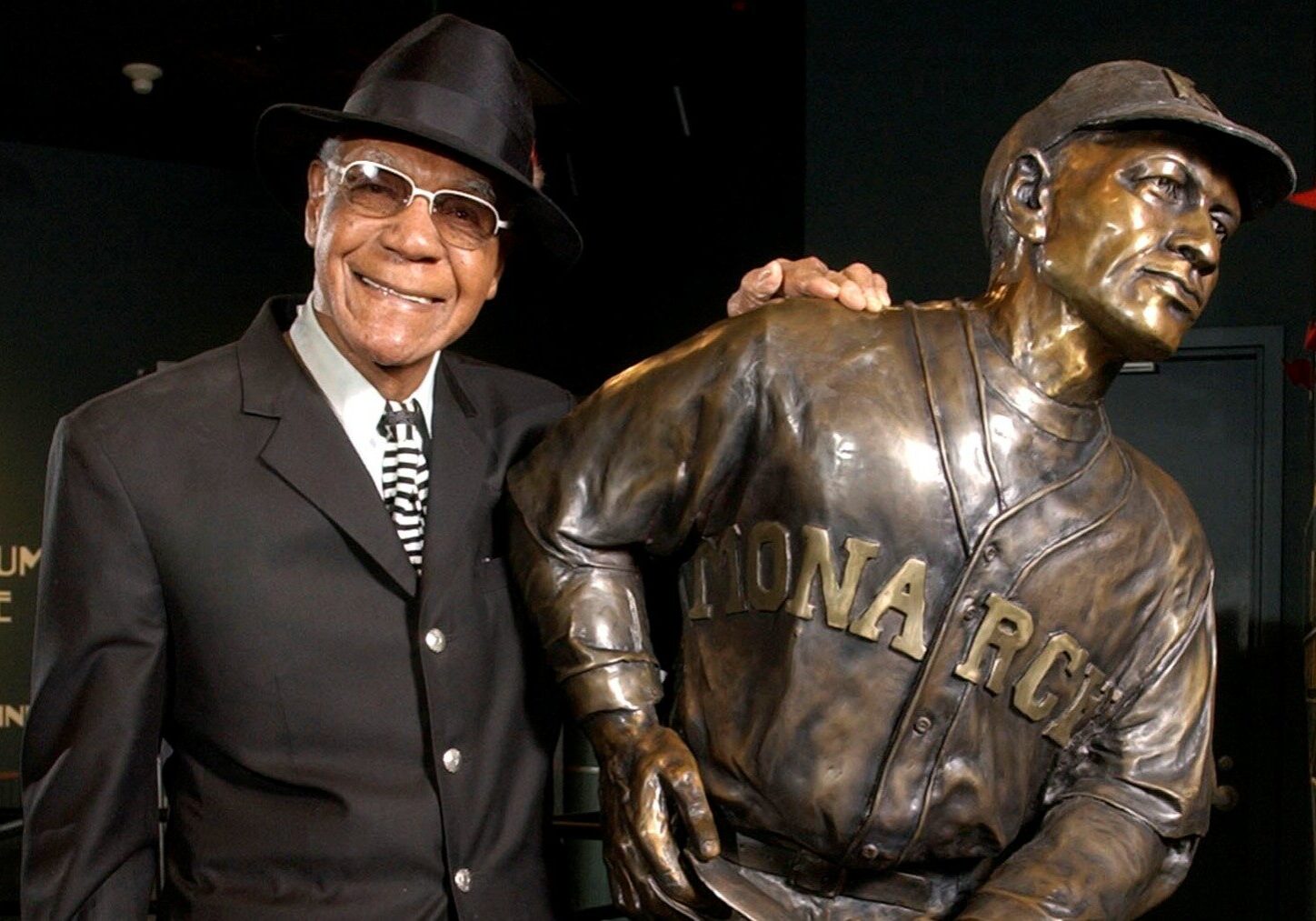Buck O'Neil stands with a statue of himself in the Negro League Baseball Museum in 2005.