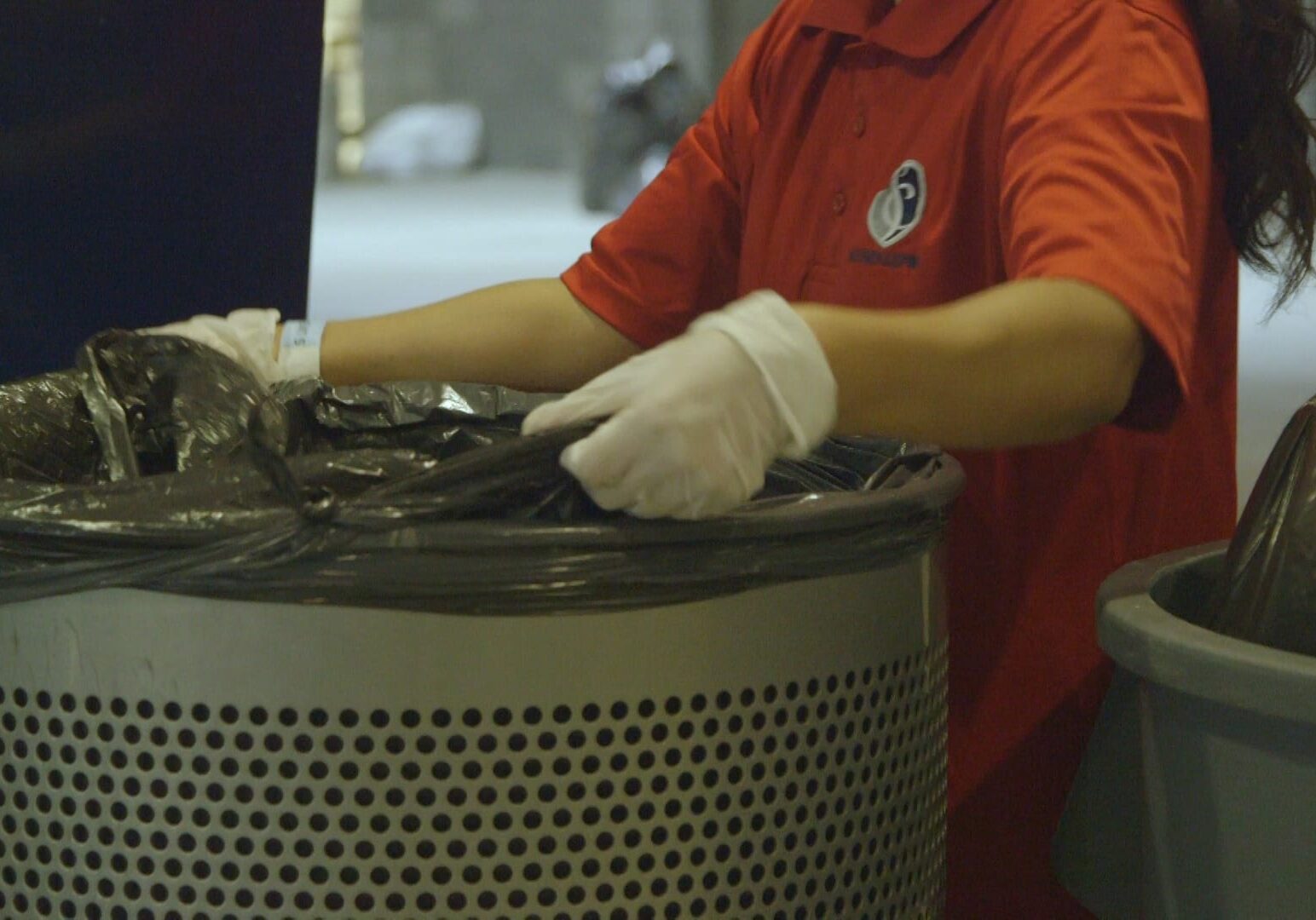 worker changing trash bag at children's mercy park in Kansas City, Kansas