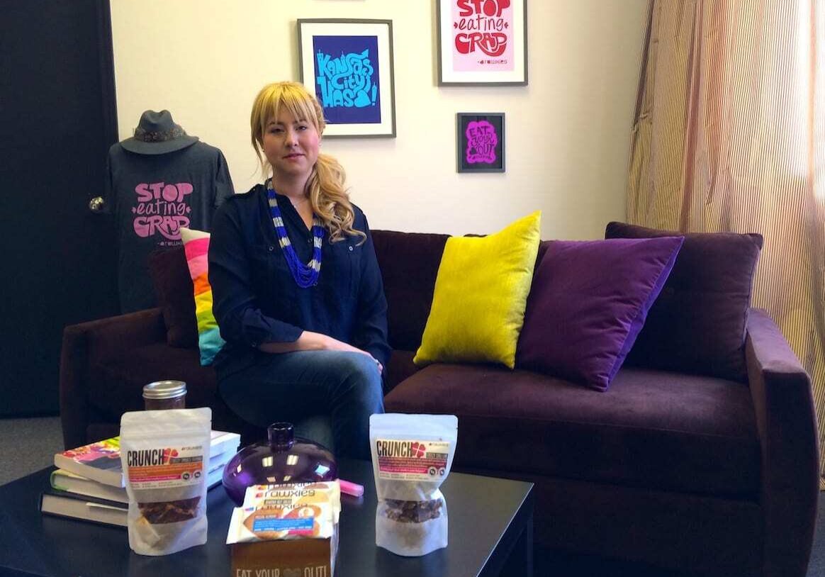 Calle England sits behind some of her Rawxies products in her Kansas City office