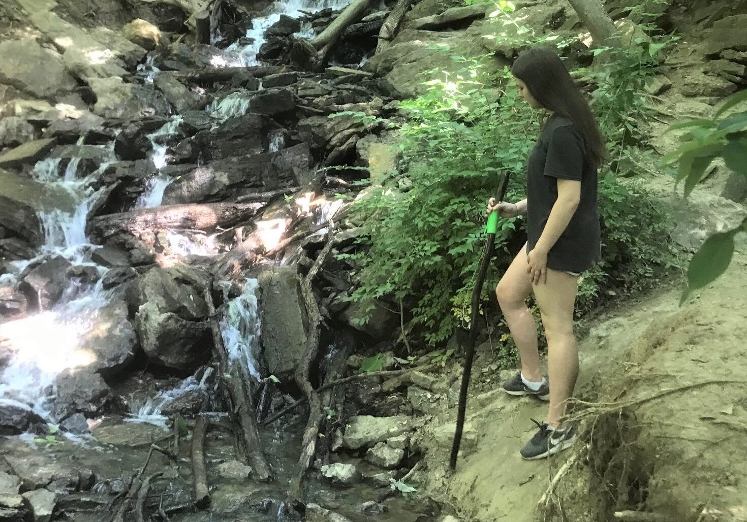 Caty Franklin of Liberty paused by a waterfall at the Parkville Nature Sanctuary.
