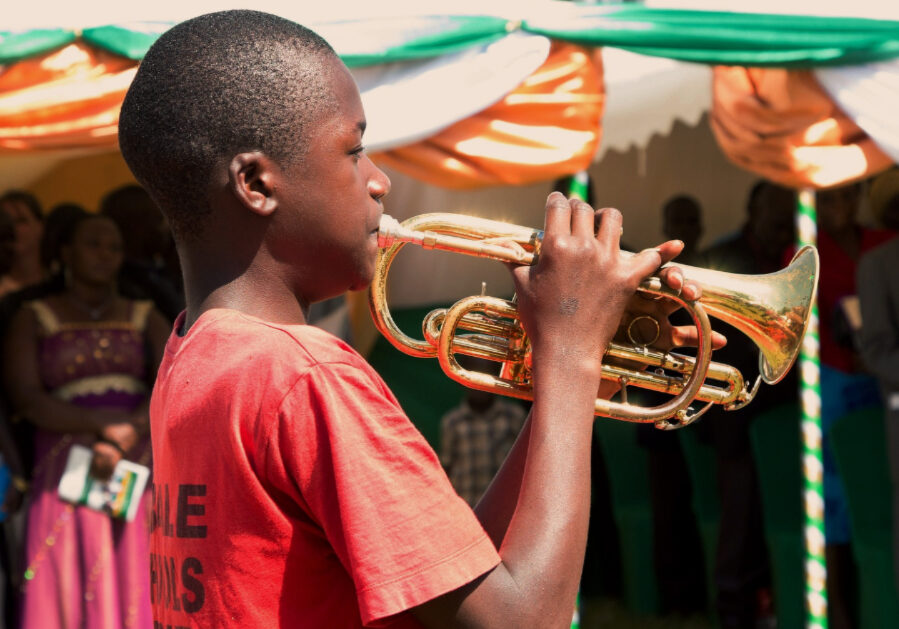 Kid playing a trumpet