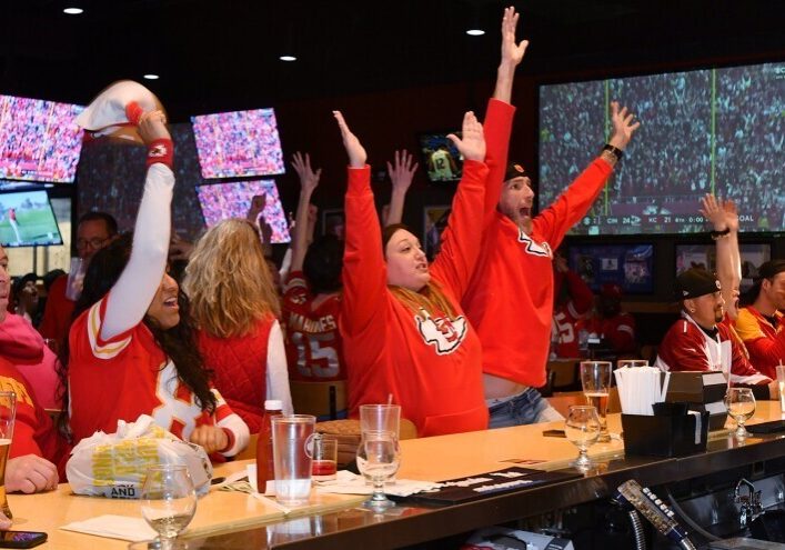 Fans at Buffalo Wild Wings in Independence, Missouri, celebrate during last year's AFC championship between the Chiefs and Bengals. Fans showed up hours before the game, sporting Chiefs merchandise and downing food and drink.