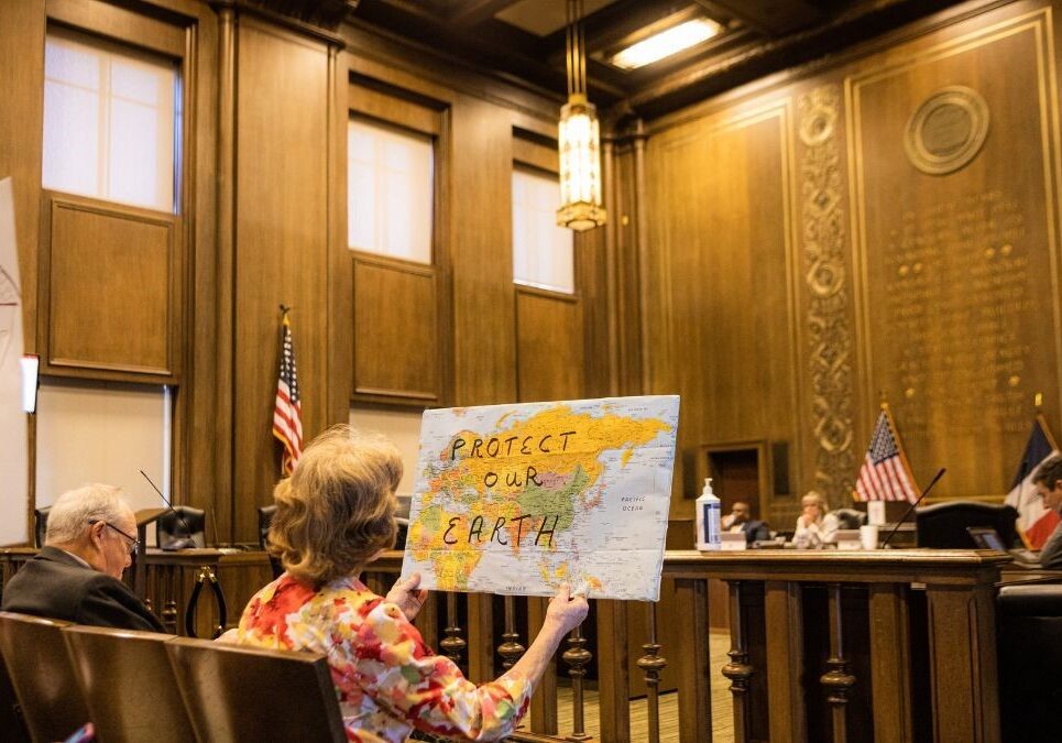 Activists sit inside City Hall on July 13, while the Neighborhood Planning and Development Committee deliberates on updating building codes. Groups like the Sierra Club and Sunrise Movement have been prominent during these meetings.