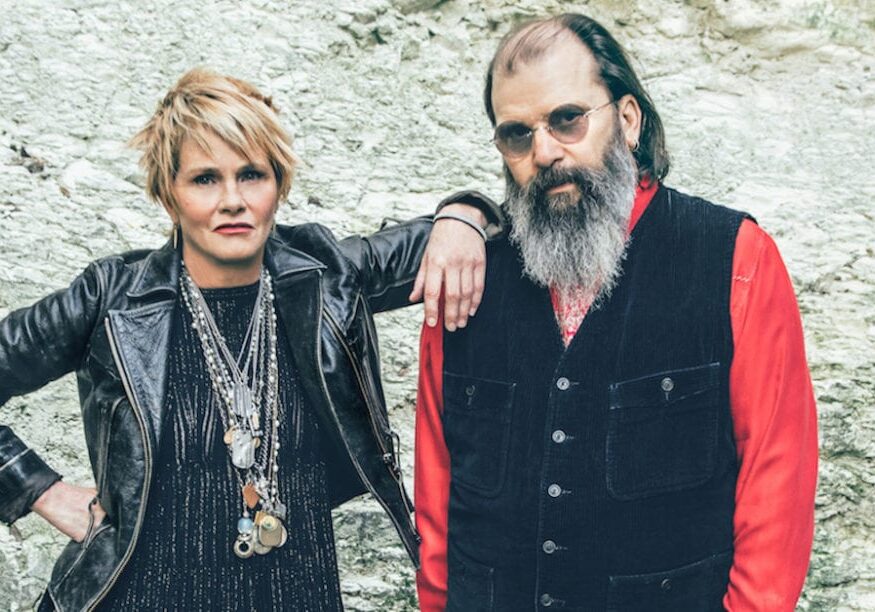 A woman and man stand next to each other.