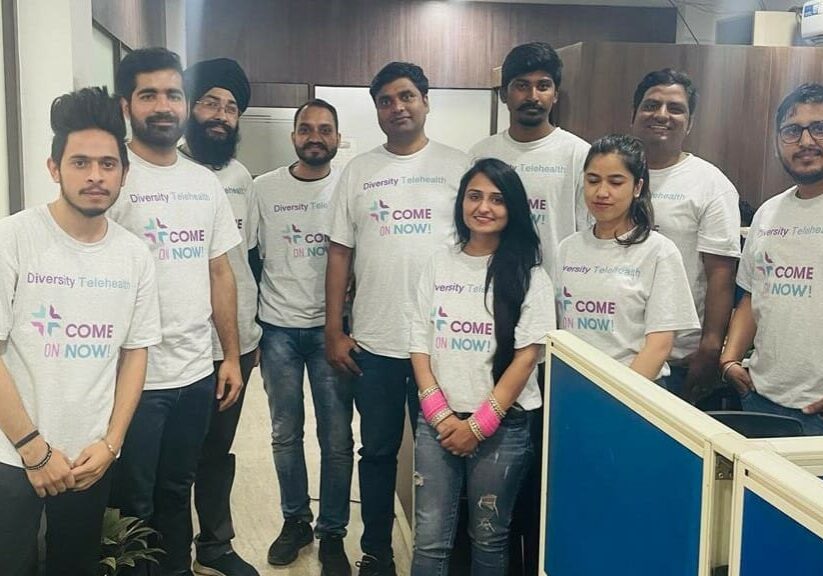 Ten people wearing Come on Now! t-shirts.