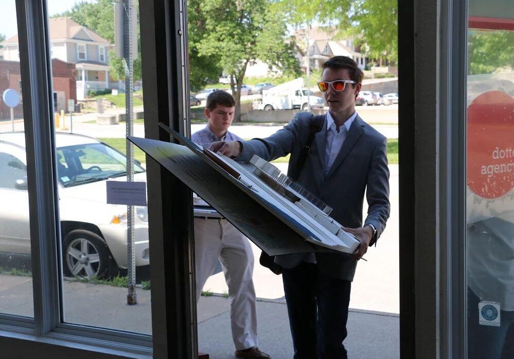 Spencer Reed, a sophomore architecture student at the University of Kansas, carries a site model for the proposed healthy campus in Kansas City, Kansas, into a new community design center located near downtown.
(Photo: Heartland Health Monitor)