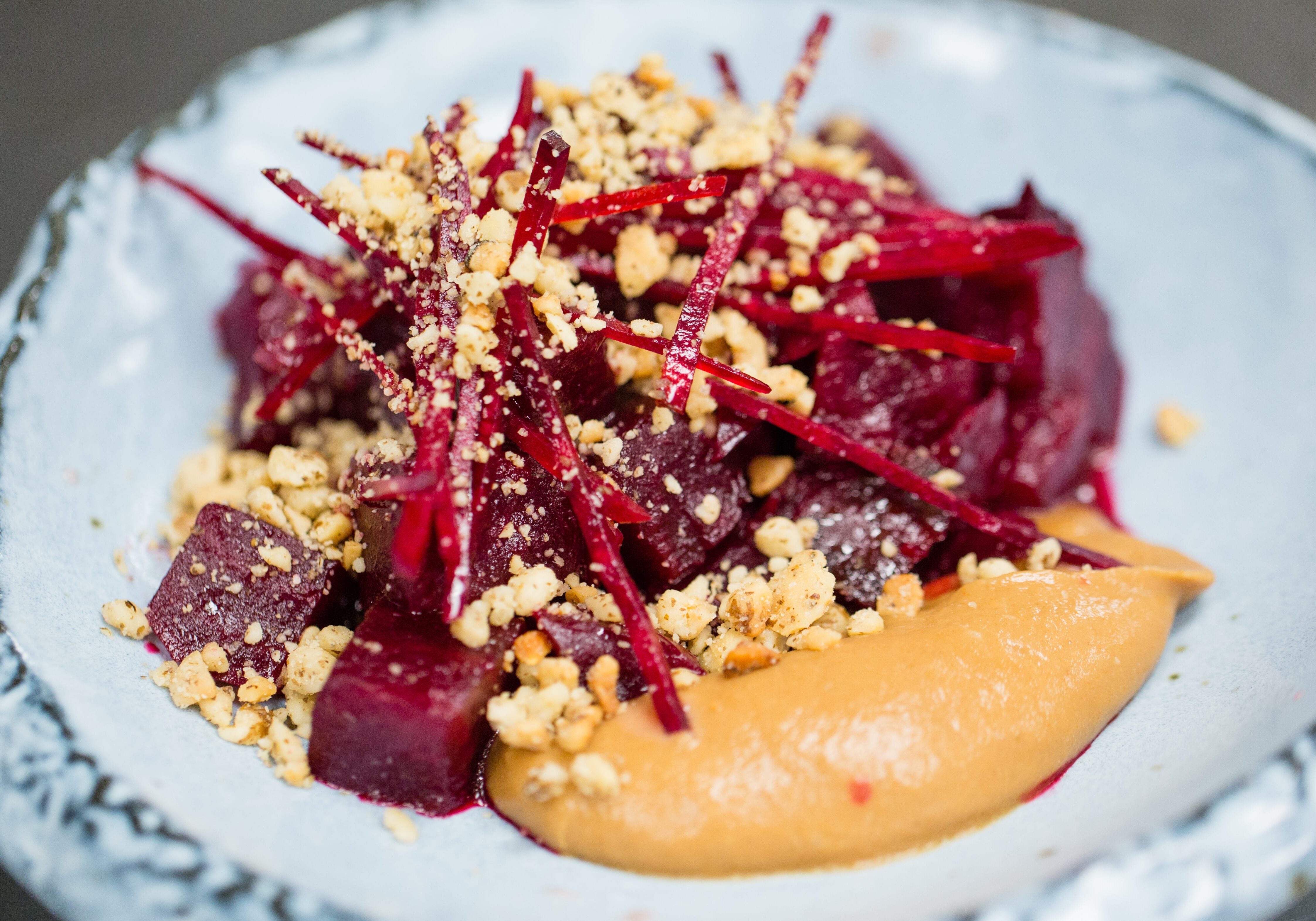 The roasted beets are served with pear butter and black walnuts at Corvino