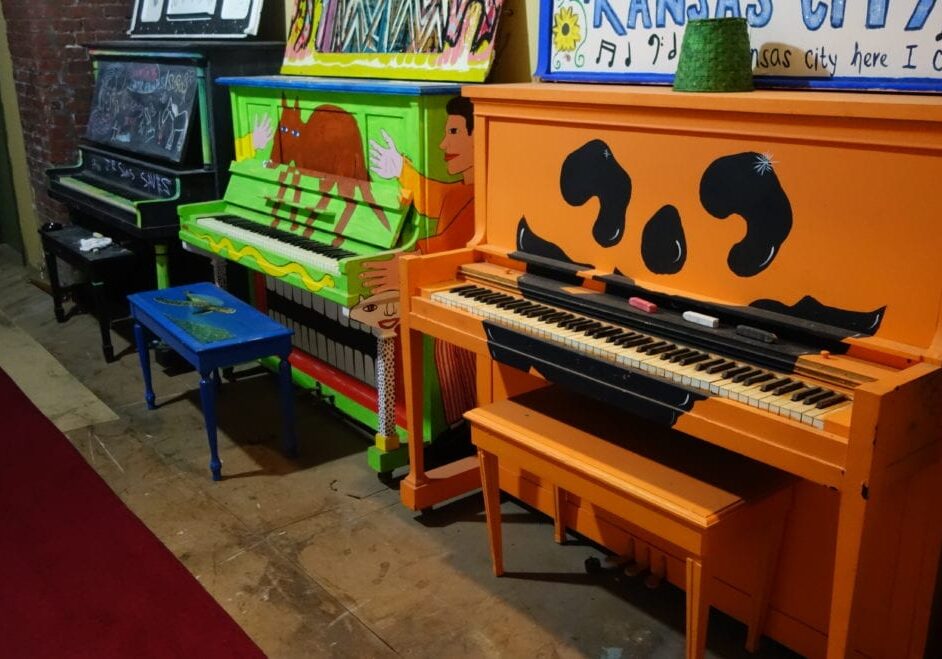 Painted pianos in a line.