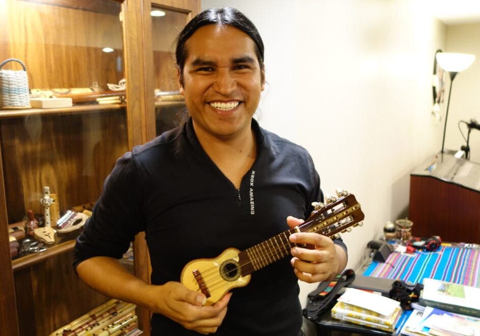 A man holds the instrument "baby charango"