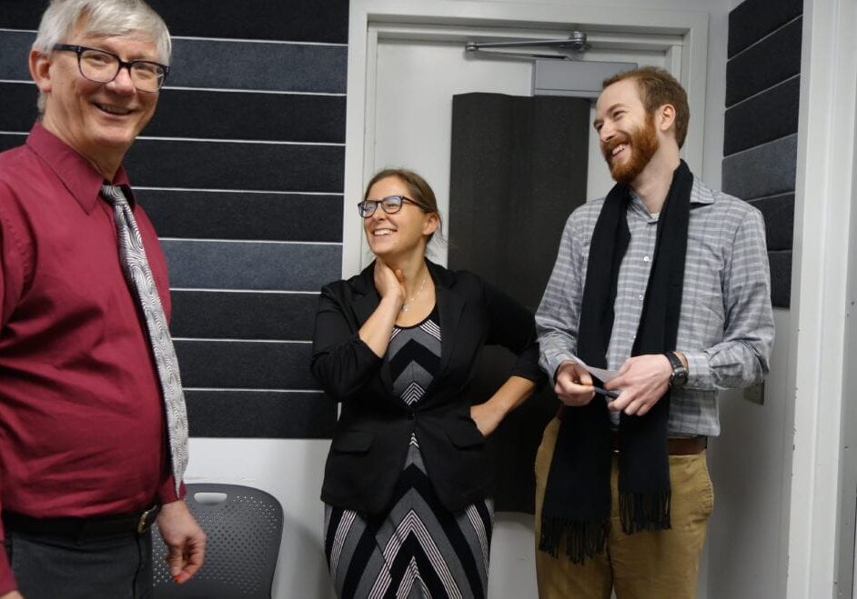 Three individuals laughing together.