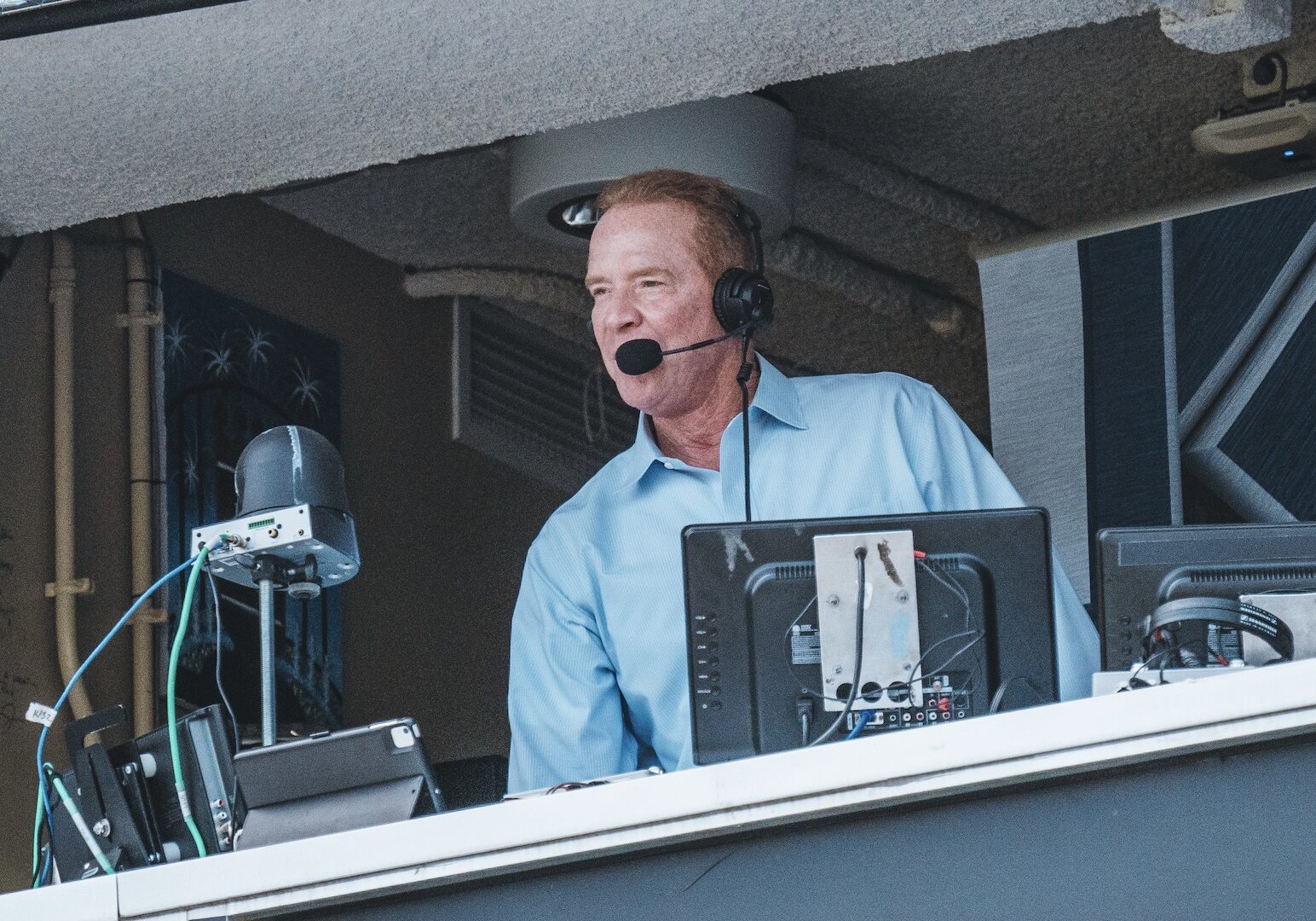 Rex Hudler making a call in the press box.