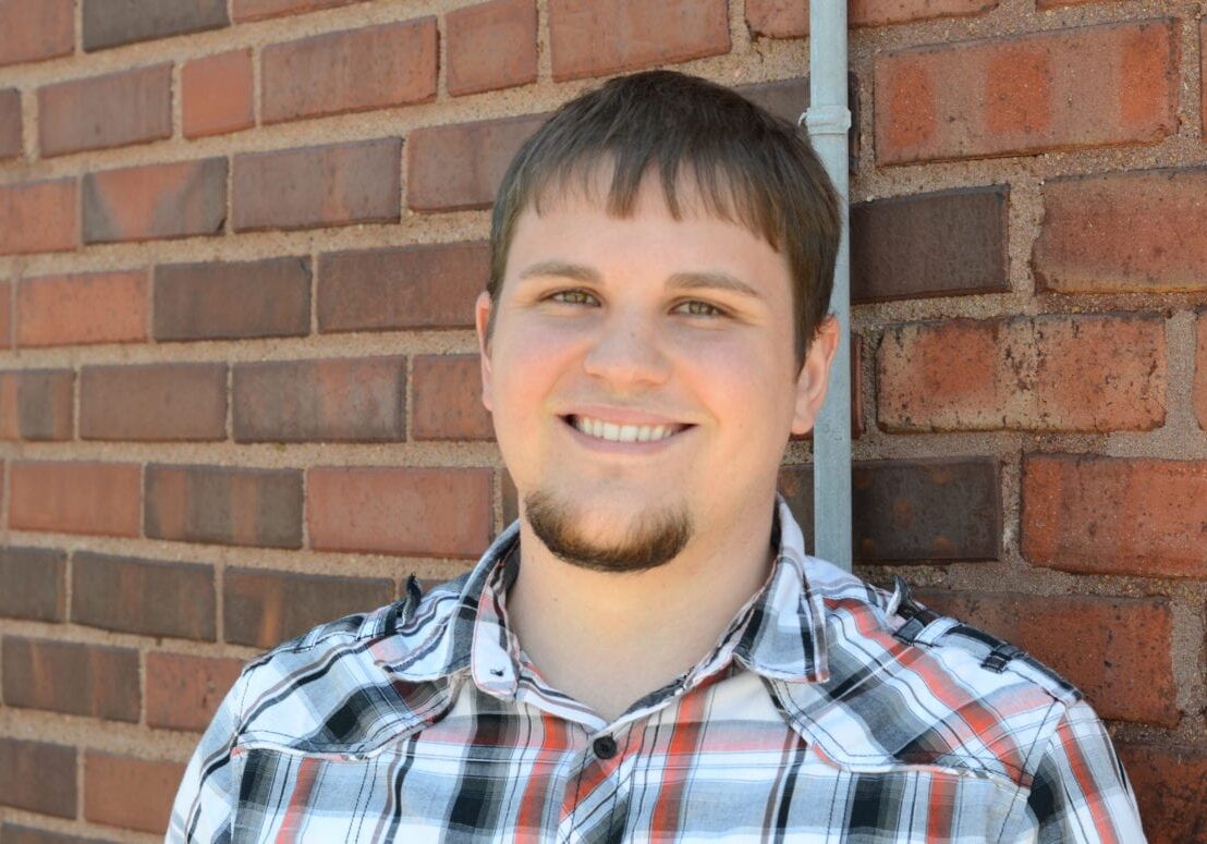 A man i front of a wall