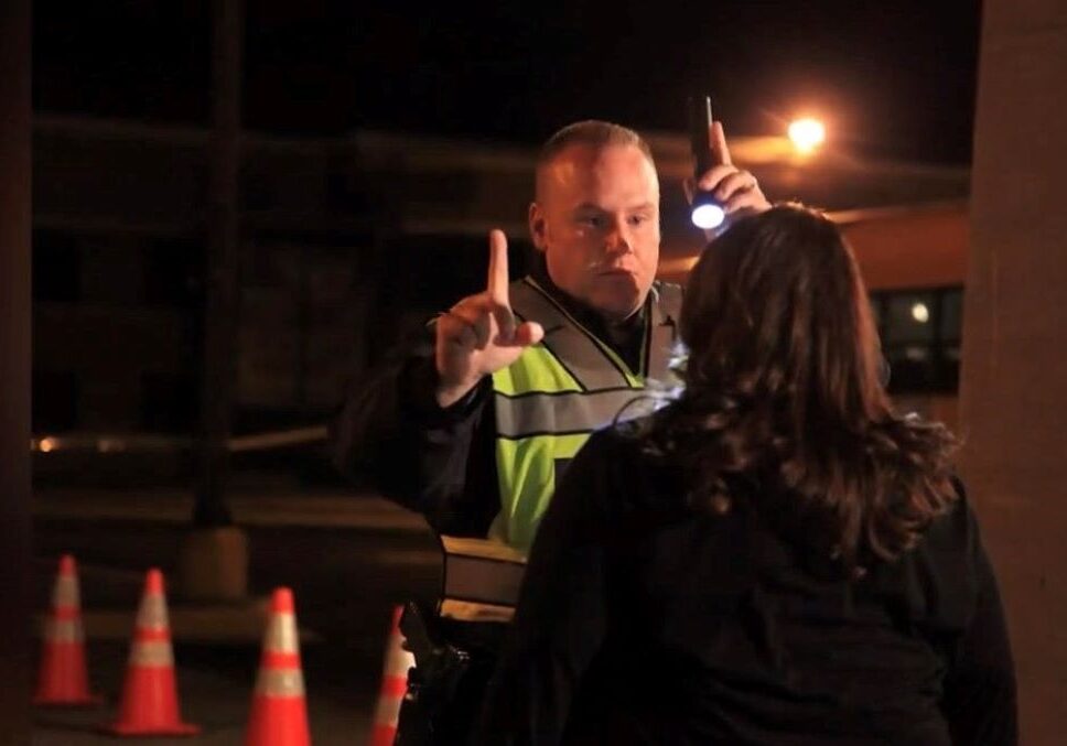 A Kansas City police officer administers a sobriety field test.