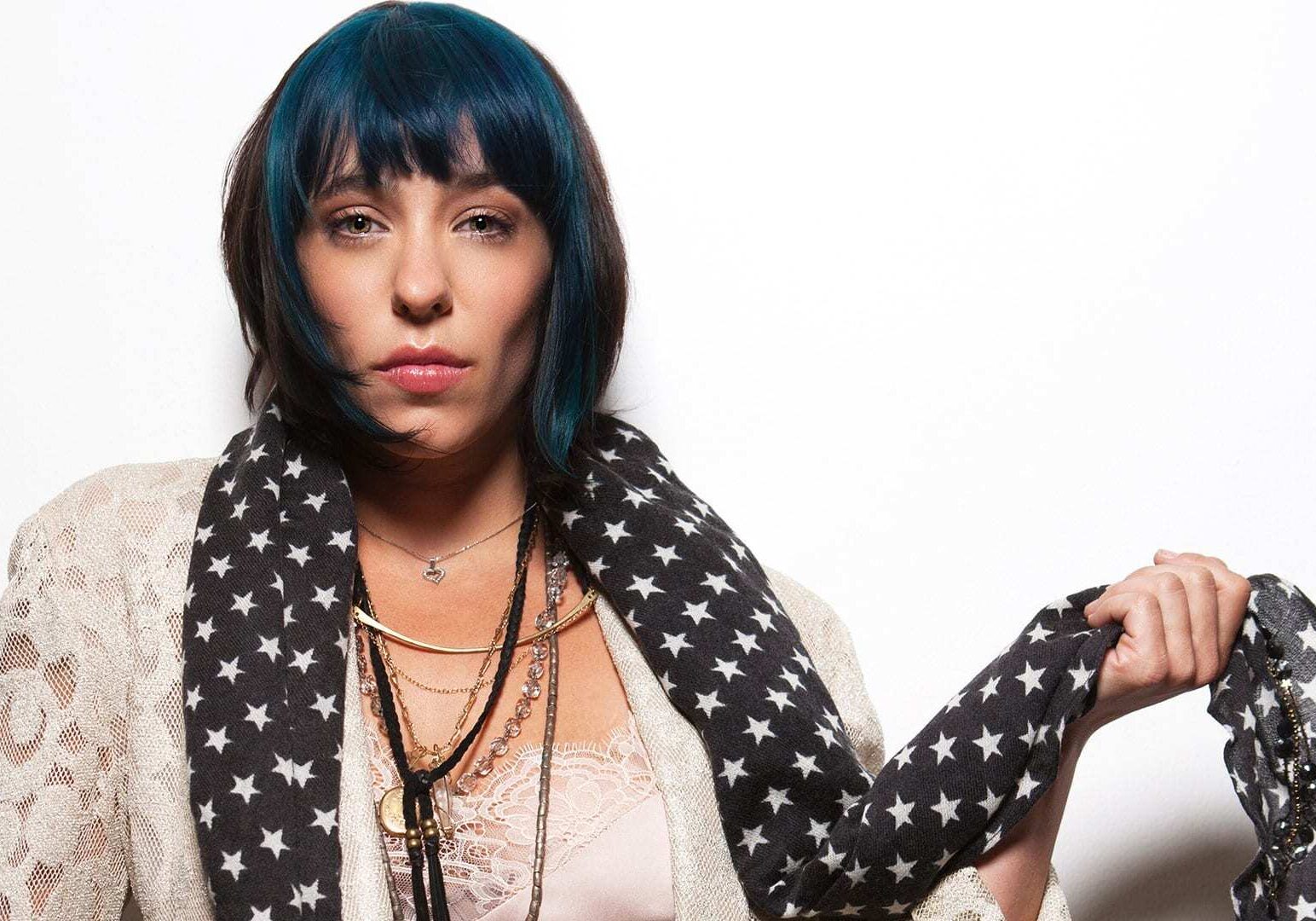 woman w/ blue and black hair poses for the camera