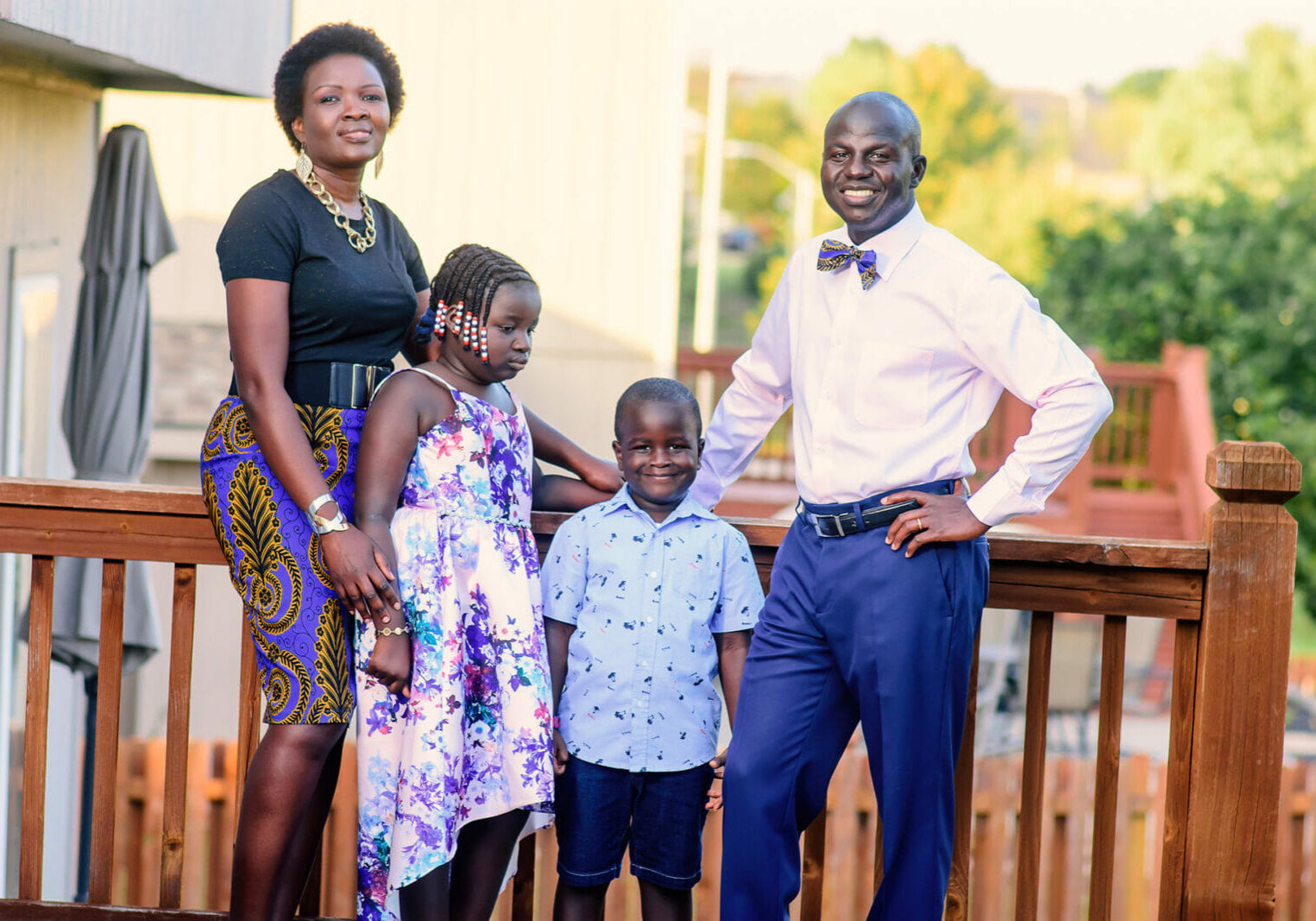 A family picture, outside on a wooden deck. In the 1990s, Denis Kweri was a young 20-something fleeing from the second Sudanese Civil War. He and his family made their way to Kansas City where he says he found a home and hope. Now he wants to pay it forward. (Contributed)