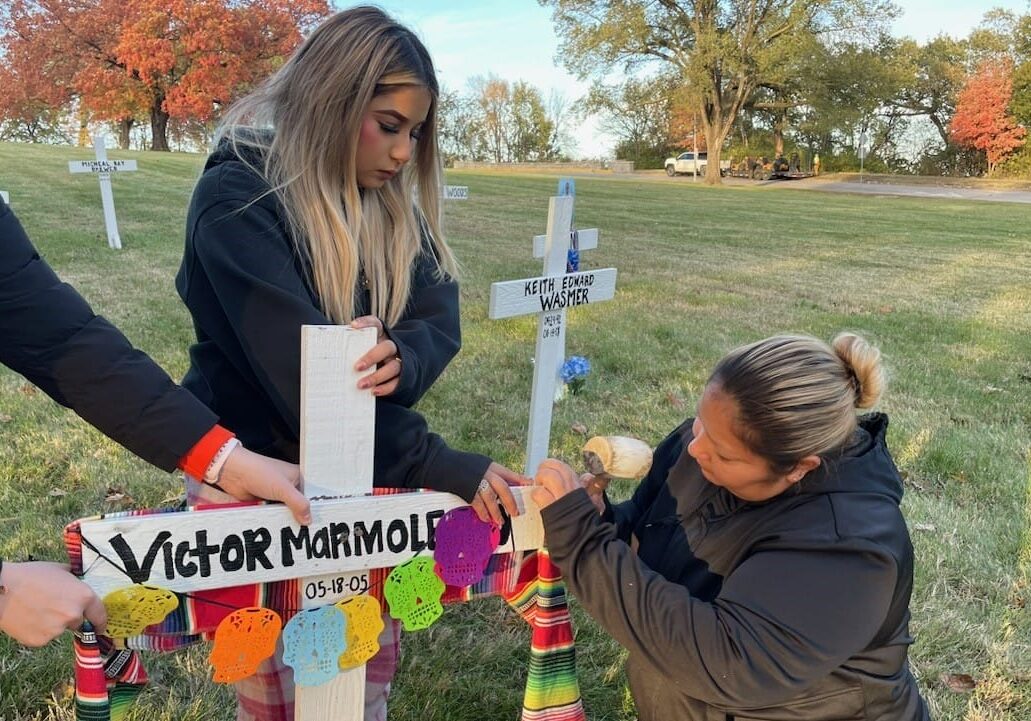 Mother and daughter, Jazmin Marmolejo and Erika Gaitan carried a supply of decorations to a site in Northeast Kansas City this week, items that they used to create a tribute to the memory of Victor Marmolejo, their son and brother.