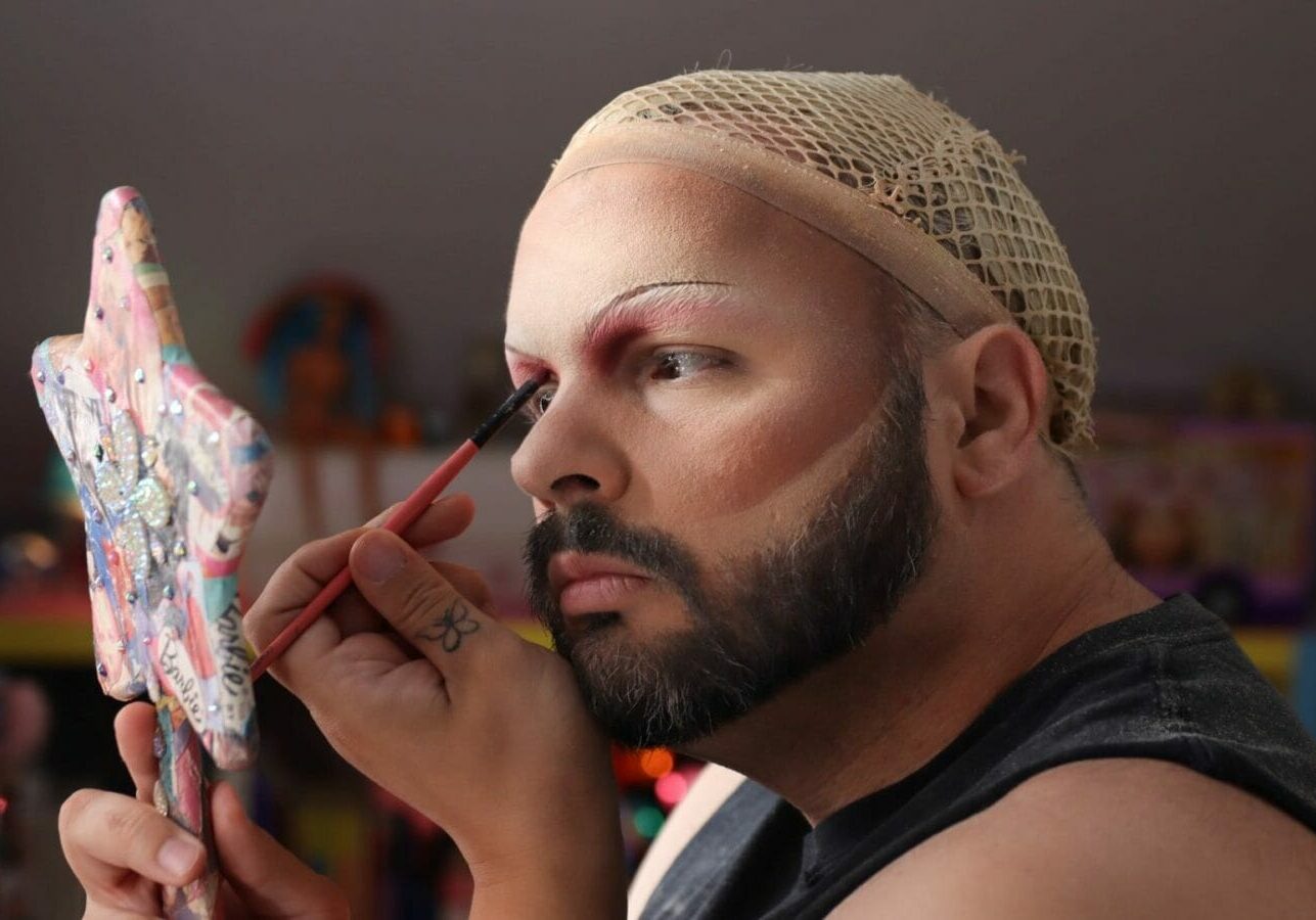 Drag Queen “Manic High” applying makeup.